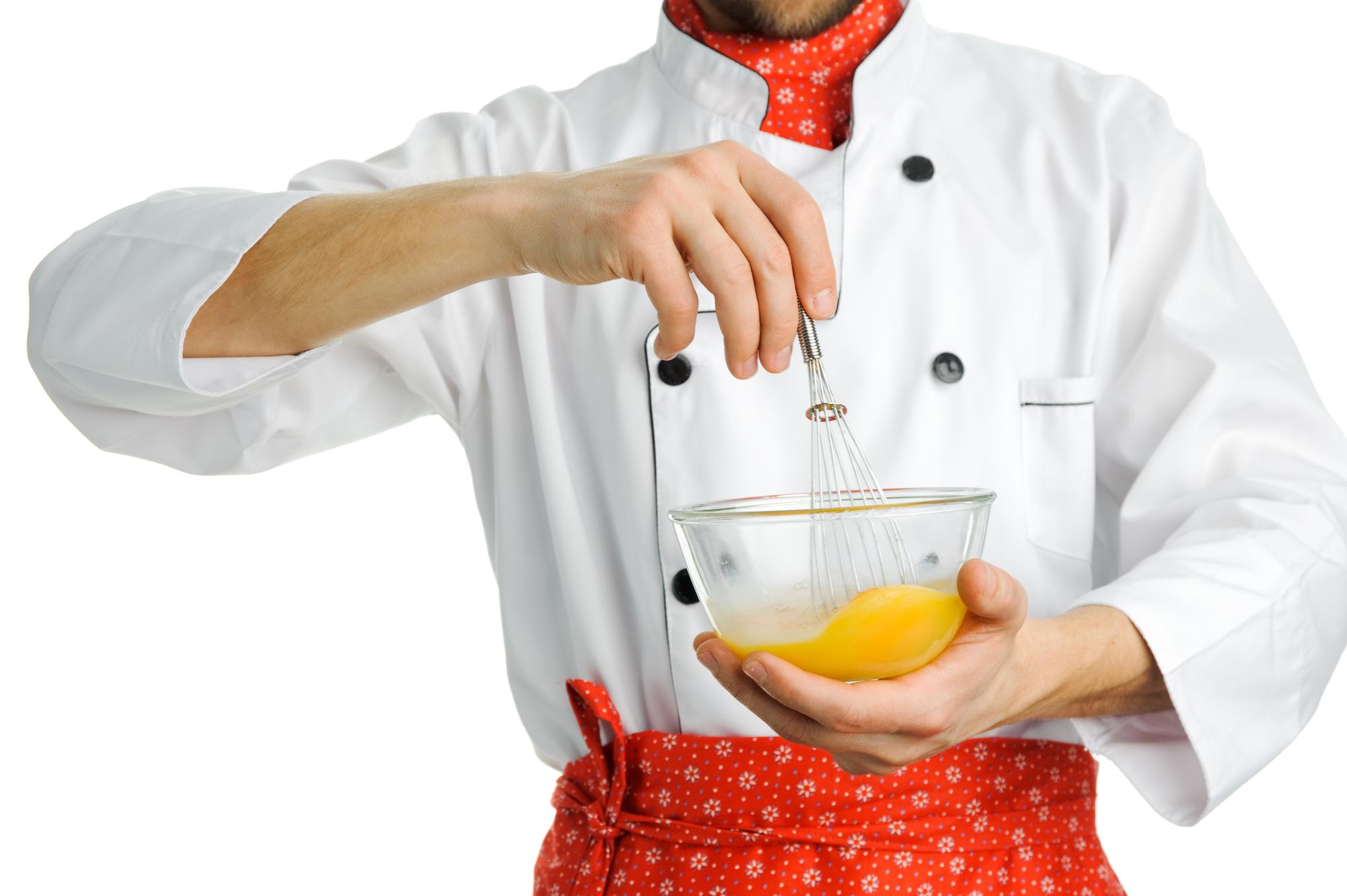 Chefs preparing plated dishes with modern tools